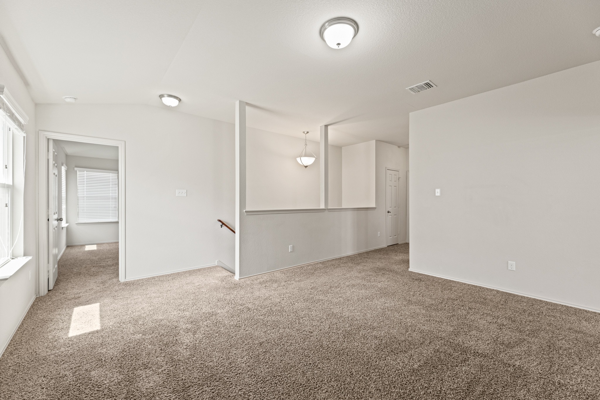 232 Geode Lane Jarrell, TX 76537 - Photo 24 of 39 The versatile upper-level loft or second living area features wall-to-wall carpeting and neutral architectural finishes.