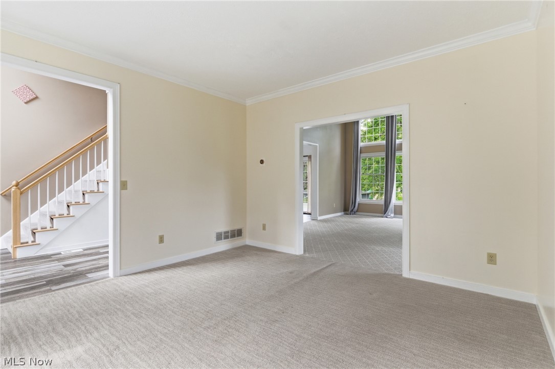 11678 Dunham Road Northfield, OH 44067 - Photo 10 of 38 Carpeted interior space featuring crown molding and baseboards
