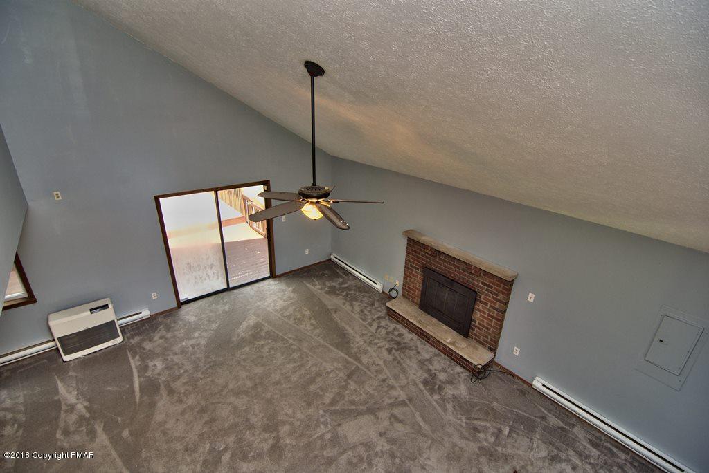 4112 Blueberry Hill Road Bushkill, PA 18324 - Photo 31 of 39 a view of an empty room with a fireplace and a window