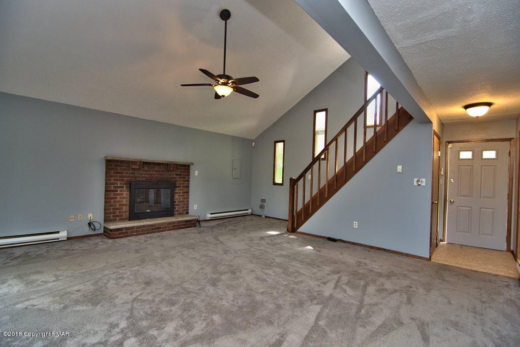 4112 Blueberry Hill Road Bushkill, PA 18324 - Photo 5 of 39 a view of an empty room with a fireplace