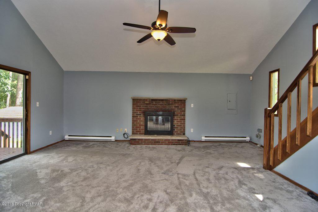 4112 Blueberry Hill Road Bushkill, PA 18324 - Photo 6 of 39 a view of an empty room with chandelier fan and a window