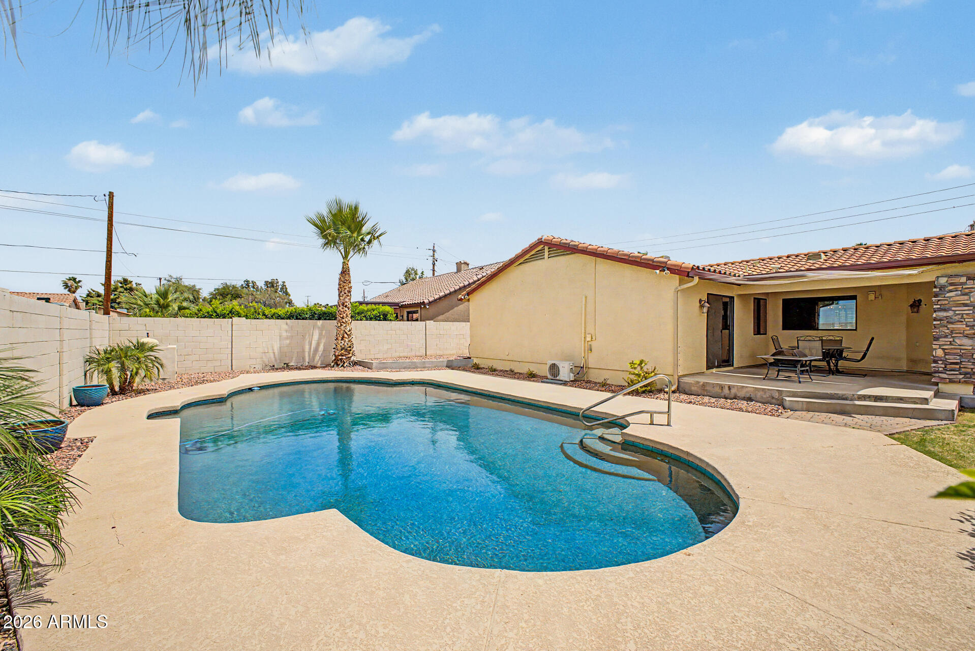 802 East Roberts Road Phoenix, AZ 85022 - Photo 20 of 24 a view of a swimming pool with a lounge chairs