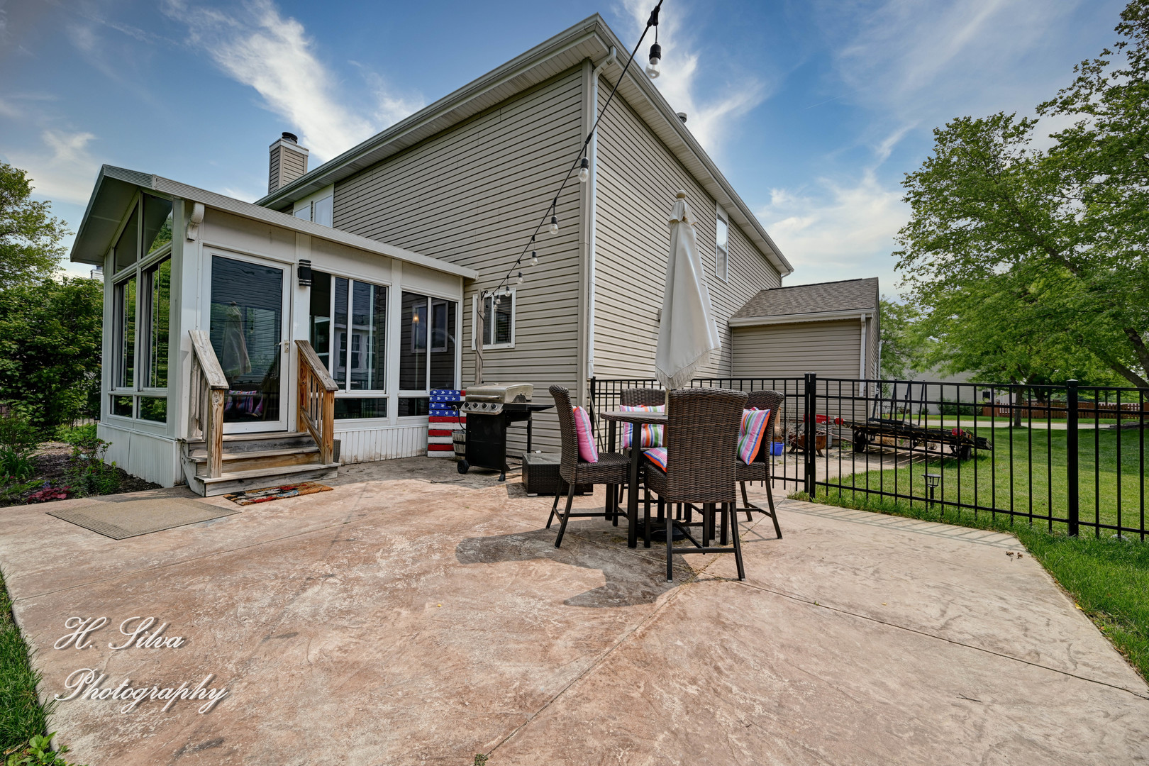 602 Spring Drive Marengo, IL 60152 - Photo 23 of 25 a view of a house with a patio and a garden