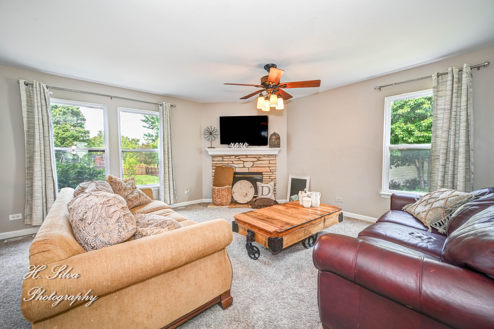 602 Spring Drive Marengo, IL 60152 - Photo 4 of 25 a living room with furniture a fireplace and a flat screen tv