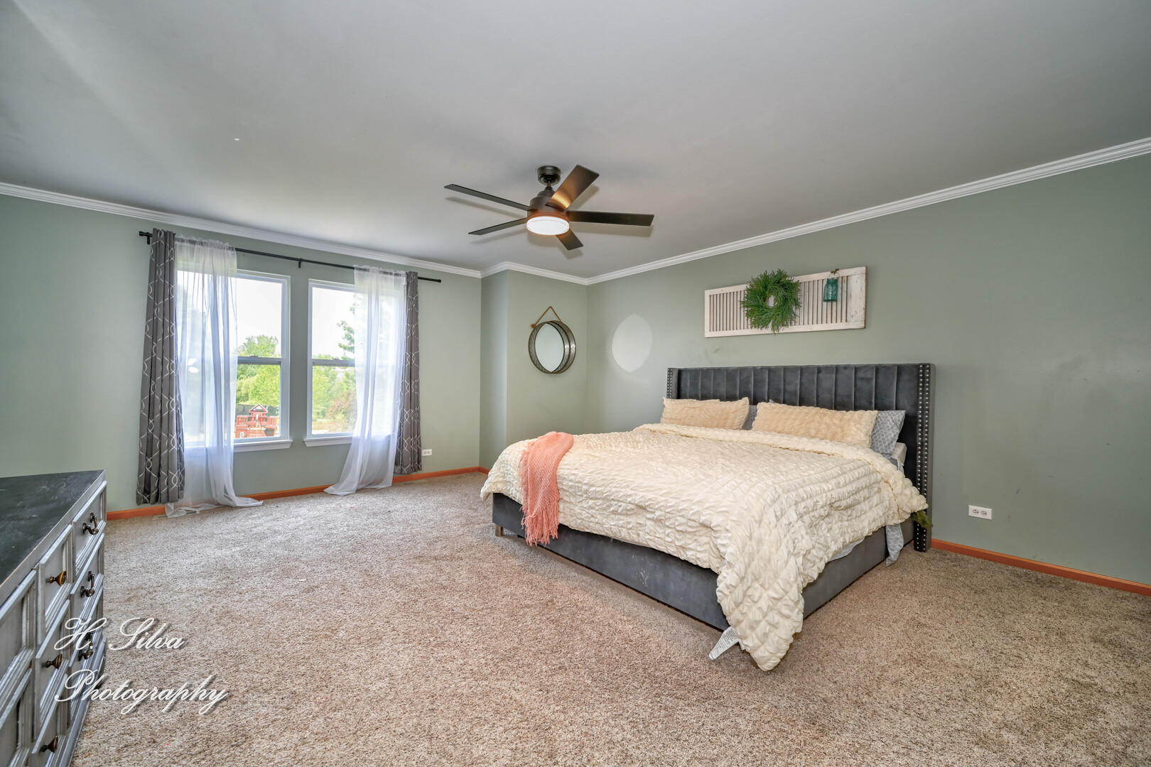 602 Spring Drive Marengo, IL 60152 - Photo 10 of 25 a spacious bedroom with a bed and a ceiling fan