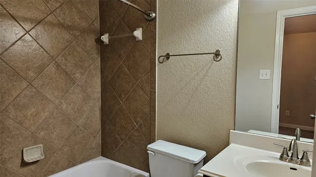 a kitchen with stainless steel appliances granite countertop a stove a sink and a refrigerator with wooden cabinets