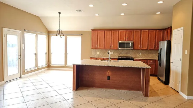 a view of a bathroom with a granite countertop sink a mirror and a shower