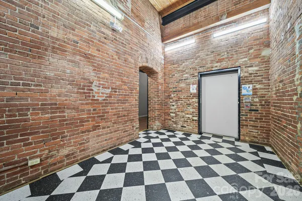 a bathroom with a black and white checkered floor