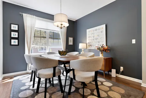a view of a dining room with furniture wooden floor and chandelier