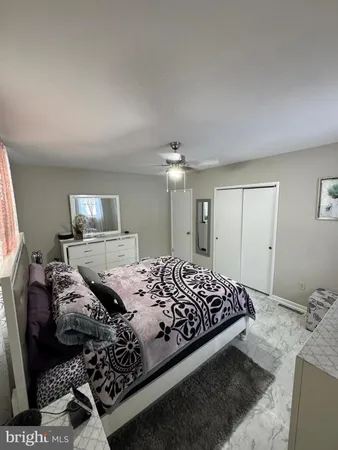 a bedroom with a bed and a mirror on dresser