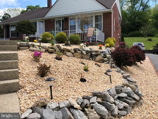 a view of a house with yard and sitting area