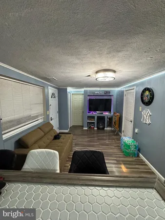 a bed sitting in a bedroom and chandelier