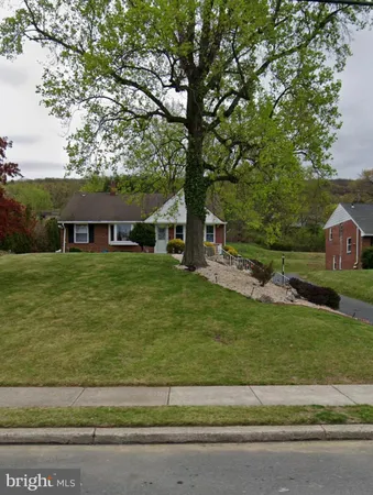 a view of house with yard