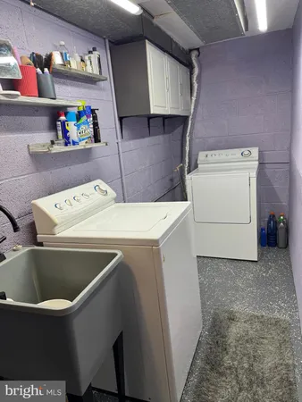 a view of water heater room with washer and dryer