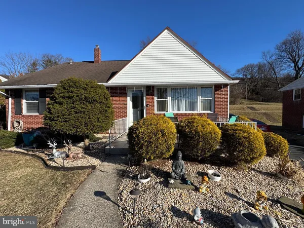 a front view of a house with yard and seating area
