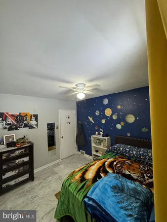 a bedroom with furniture and a flat screen tv