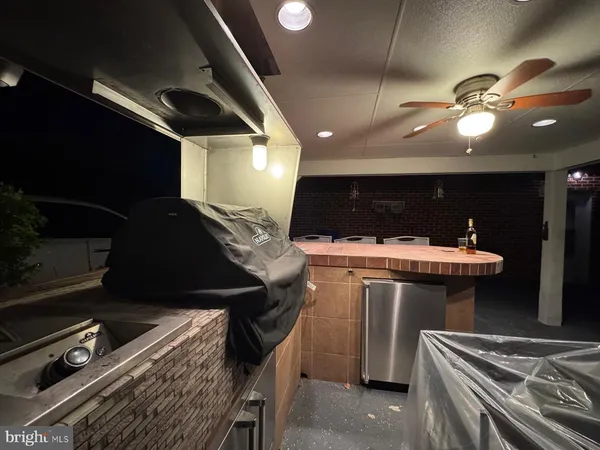 a kitchen with a sink stainless steel appliances and furniture