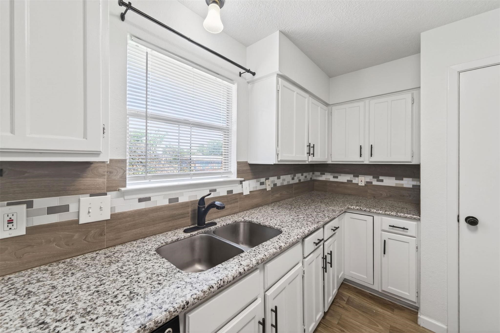 17002 Dew Drop Lane Houston, TX 77095 - Photo 10 of 24 a kitchen with a sink cabinets and window