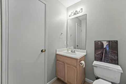 a bathroom with a toilet a sink and mirror