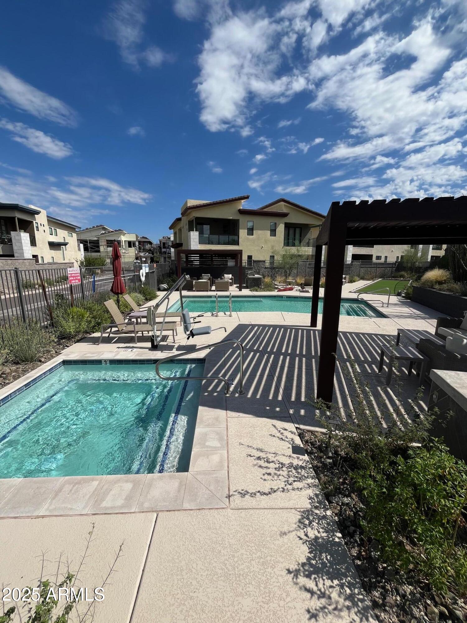 1 Easy Street, Unit 12 Carefree, AZ 85377 - Photo 41 of 43 a view of a patio with table and chairs a barbeque and potted plants
