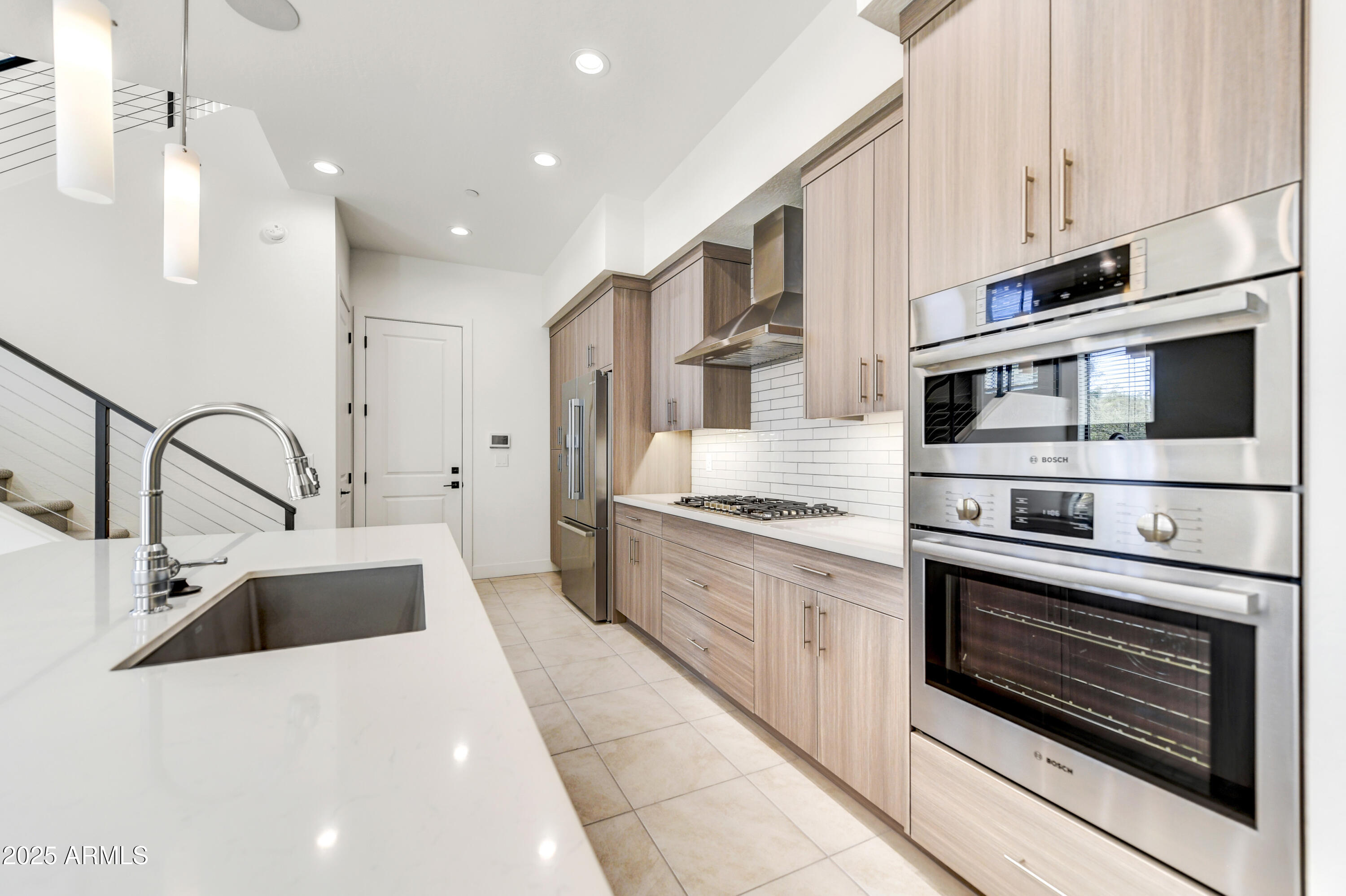 1 Easy Street, Unit 12 Carefree, AZ 85377 - Photo 8 of 43 a kitchen with stainless steel appliances kitchen island granite countertop a sink and stove top oven