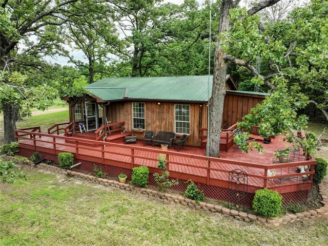 a view of a deck with wooden floor and fence