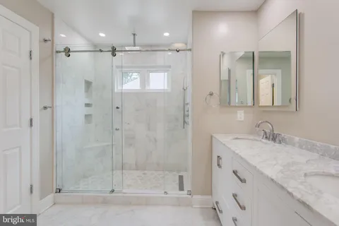 a bathroom with a shower sink and mirror