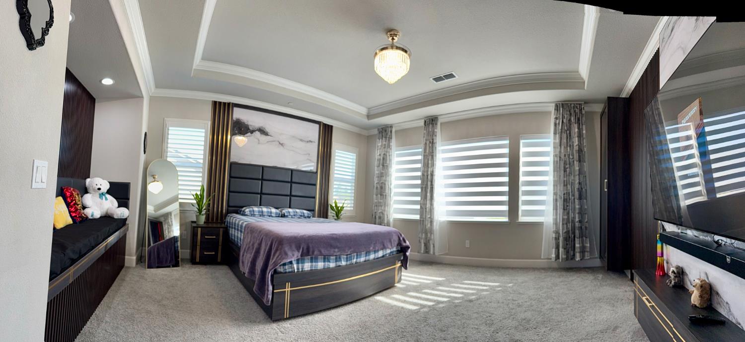 260 Seneca Way Lodi, CA 95240 - Photo 27 of 57 Master bedroom with a raised ceiling, carpet flooring, and crown molding