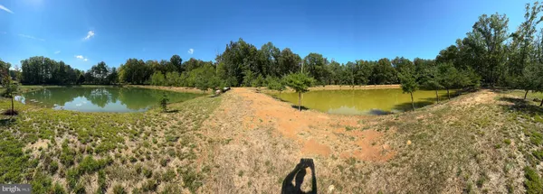 a view of a swimming pool with a lake view and a trees