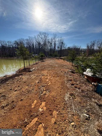 a view of a lake with houses in the back