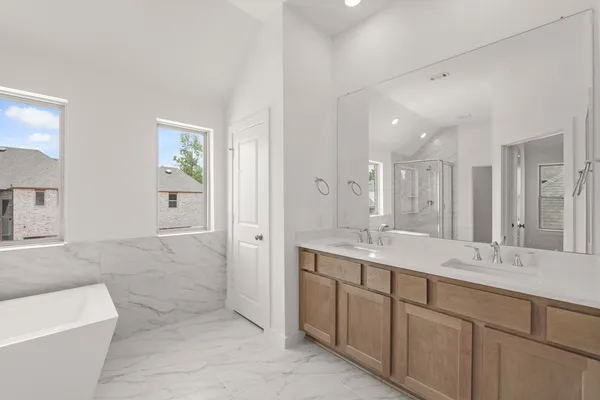 a bathroom with a tub sink and mirror