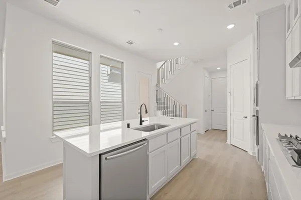 a kitchen with sink and mirror