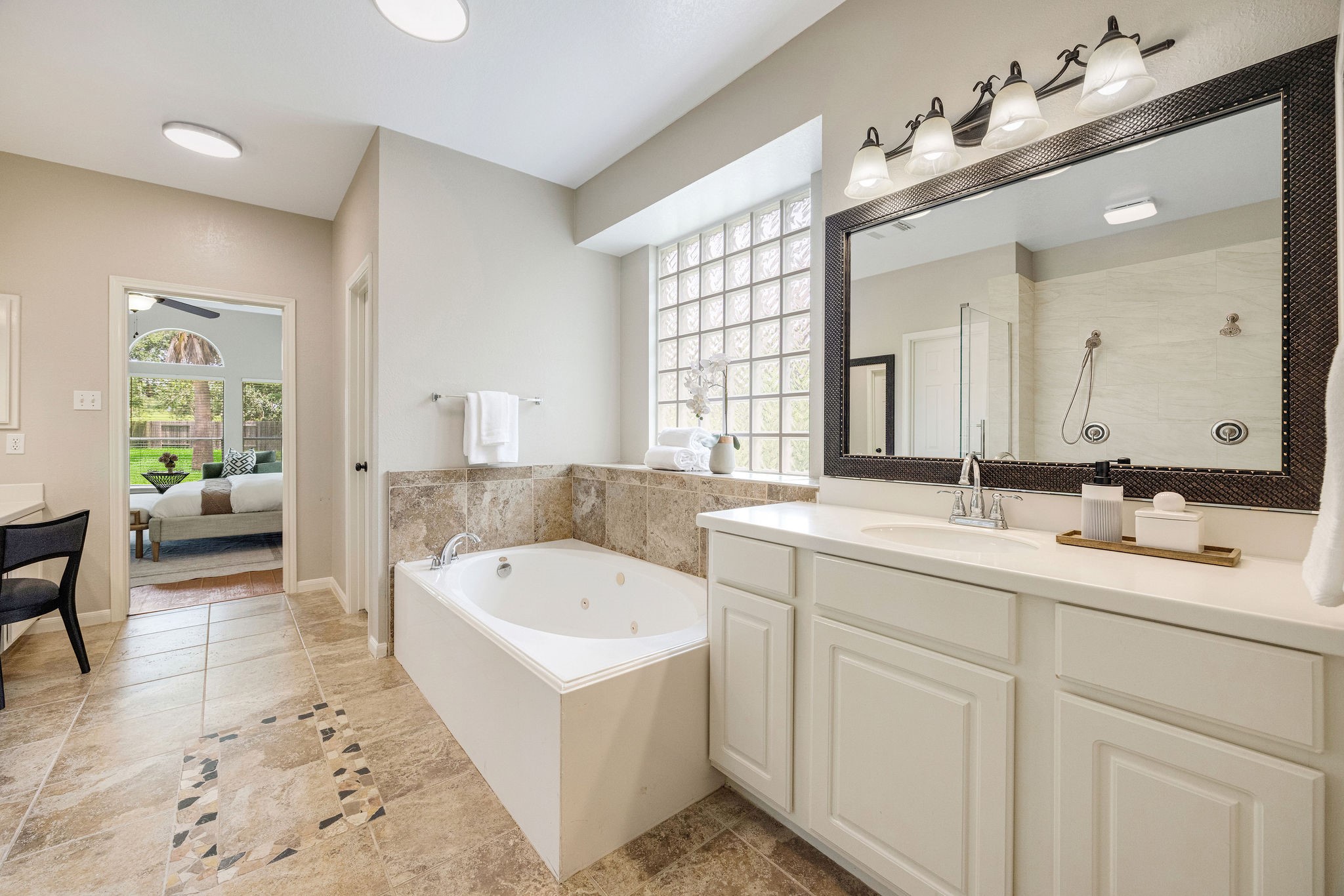 9603 Randon Lane Missouri City, TX 77459 - Photo 28 of 50 This bathroom is abundantly lit with 2 new ceiling lights and shower light/fan, wall sconces and natural lighting.