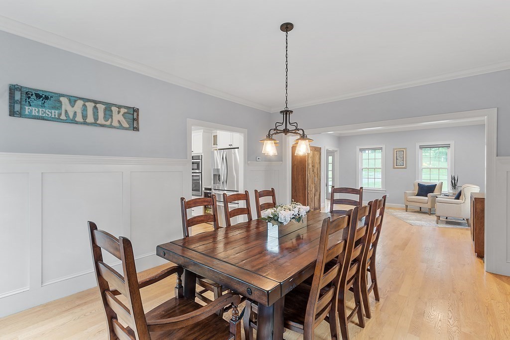 64 Mill Pond Road Bolton, MA 01740 - Photo 13 of 41 a dining room with furniture a chandelier and wooden floor