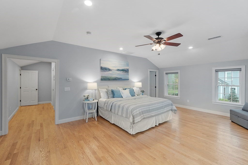 64 Mill Pond Road Bolton, MA 01740 - Photo 20 of 41 a bedroom with a bed and a chandelier