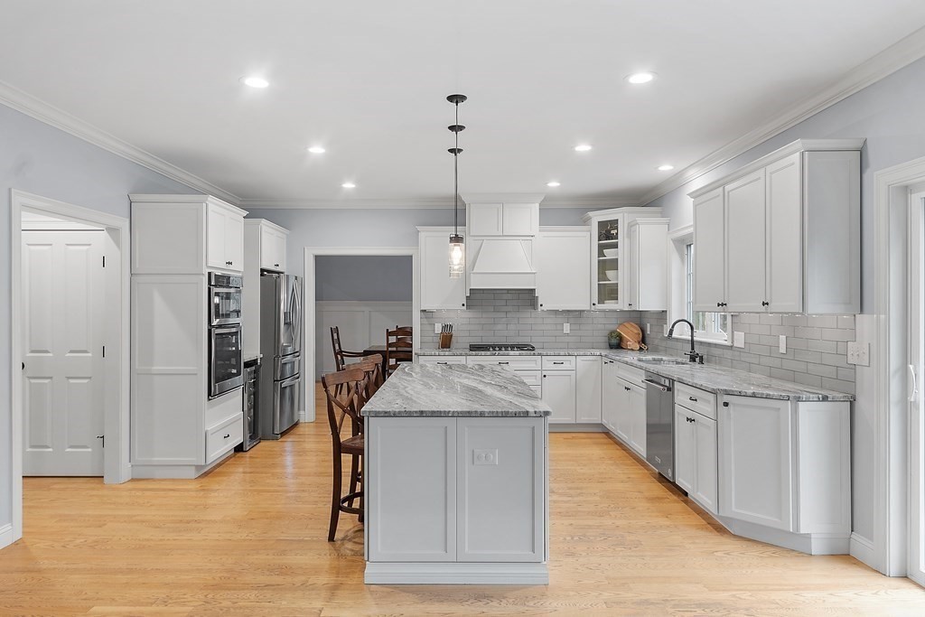 64 Mill Pond Road Bolton, MA 01740 - Photo 3 of 41 a large kitchen with kitchen island a sink stainless steel appliances and cabinets