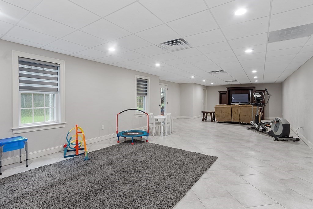 64 Mill Pond Road Bolton, MA 01740 - Photo 31 of 41 a room with gym equipment and a window