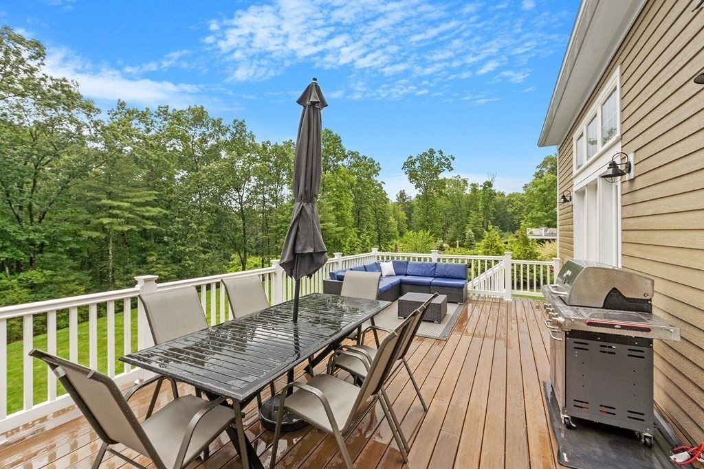 64 Mill Pond Road Bolton, MA 01740 - Photo 35 of 41 a view of a balcony with chairs and wooden floor