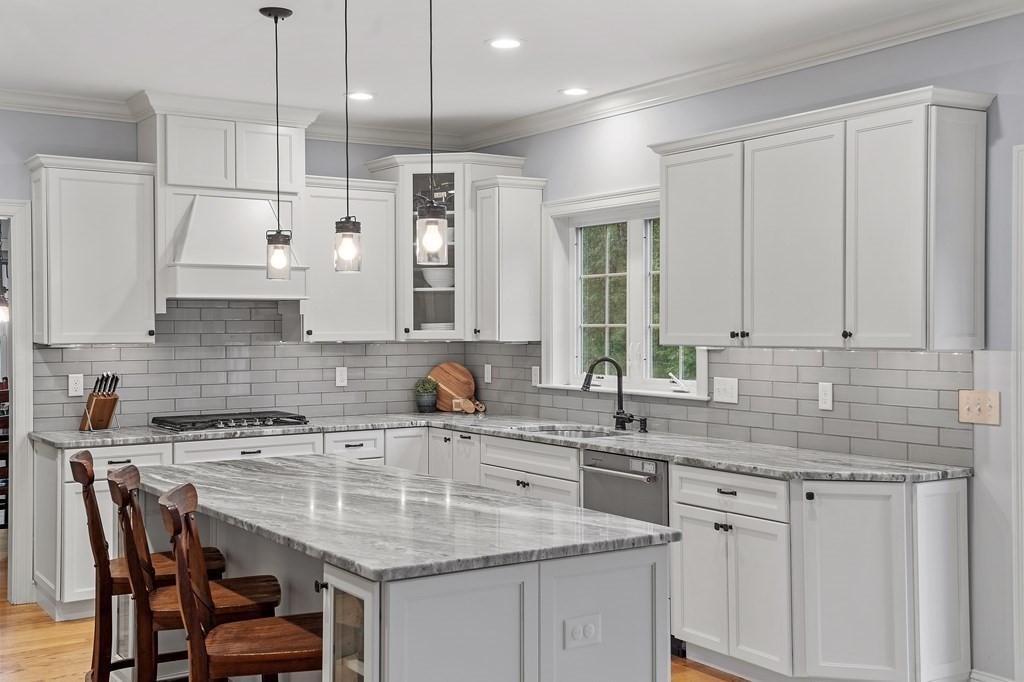 64 Mill Pond Road Bolton, MA 01740 - Photo 4 of 41 a kitchen with stainless steel appliances granite countertop a sink a white cabinets and a granite counter tops