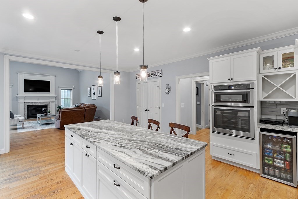 64 Mill Pond Road Bolton, MA 01740 - Photo 5 of 41 a kitchen with stainless steel appliances granite countertop a sink a stove and a wooden floor
