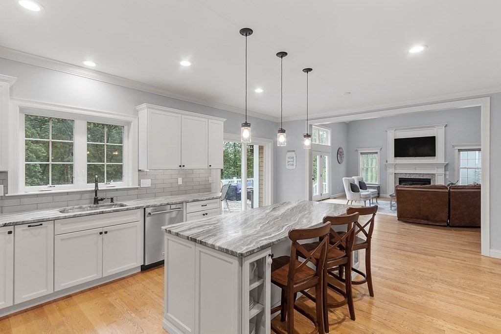 64 Mill Pond Road Bolton, MA 01740 - Photo 6 of 41 a kitchen with a table chairs sink and cabinets