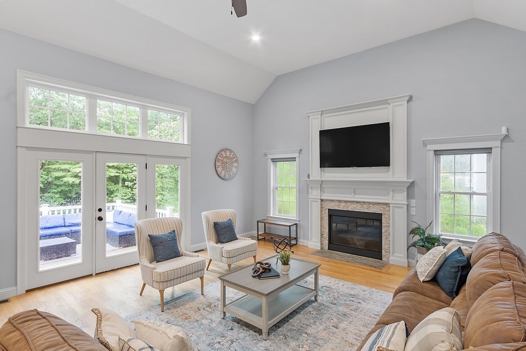 64 Mill Pond Road Bolton, MA 01740 - Photo 7 of 41 a living room with furniture a fireplace and a flat screen tv