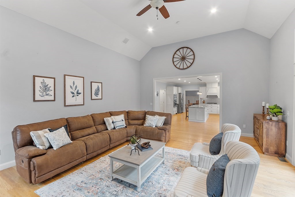 64 Mill Pond Road Bolton, MA 01740 - Photo 8 of 41 a living room with furniture a clock and a table