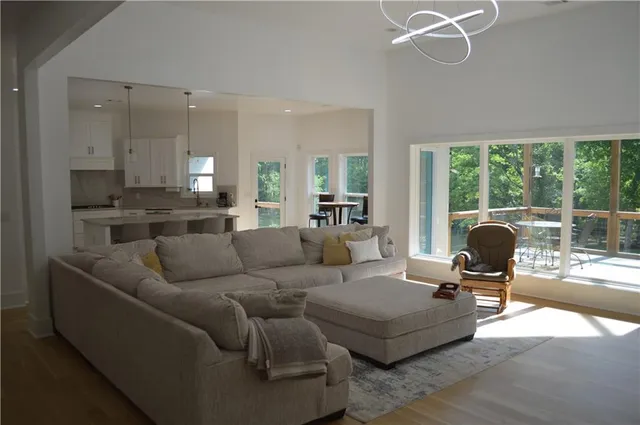 a kitchen with stainless steel appliances a stove a sink a refrigerator a center island and a counter space