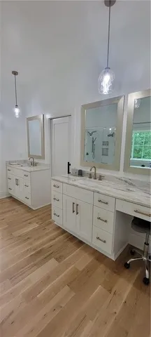 a kitchen with stainless steel appliances kitchen island granite countertop a refrigerator a stove a sink a dining table and chairs