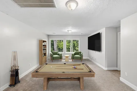 a view of a house with a yard and sitting area