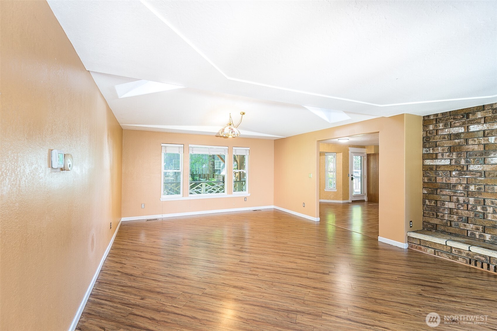 123 Forest Ridge Drive Sequim, WA 98382 - Photo 13 of 32 a view of an empty room with wooden floor and a window
