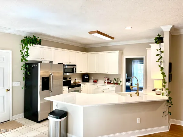 a living room with furniture and a flat screen tv with wooden floor