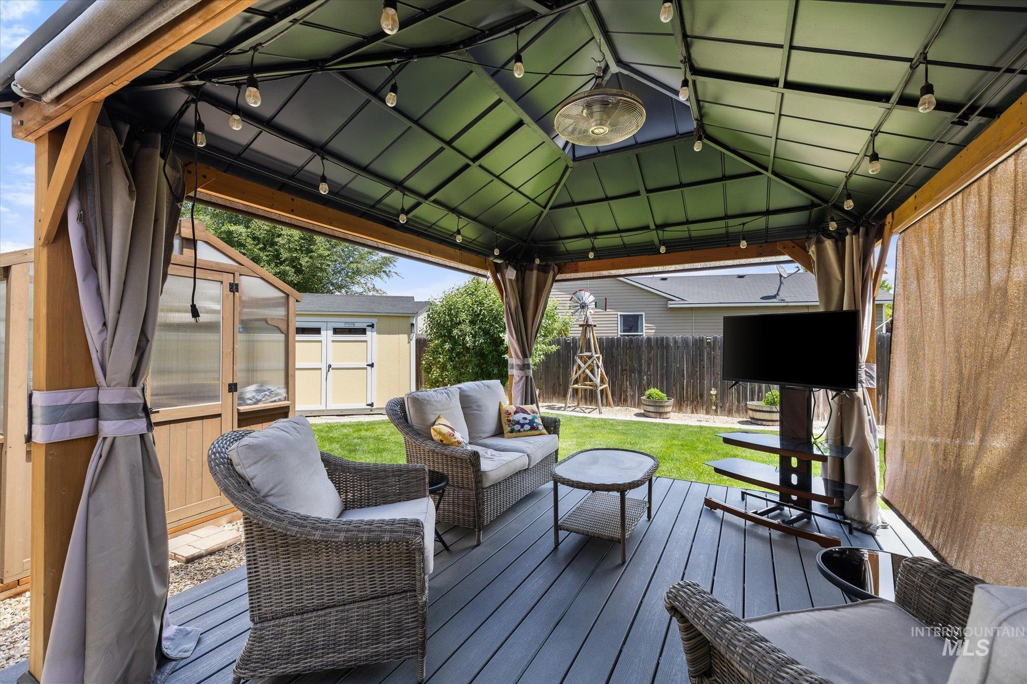 5401 Barkley Way Caldwell, ID 83607 - Photo 34 of 35 Covered patio featuring a solid roof, string lighting, and wood-finish decking