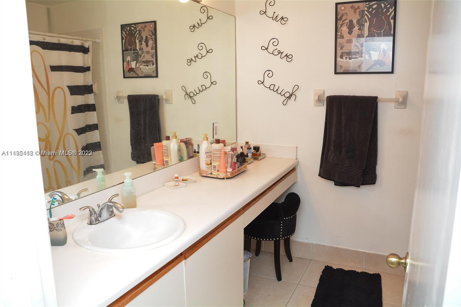 1990 Southwest 103rd Terrace Miramar, FL 33025 - Photo 14 of 19 a bathroom with a sink and a mirror